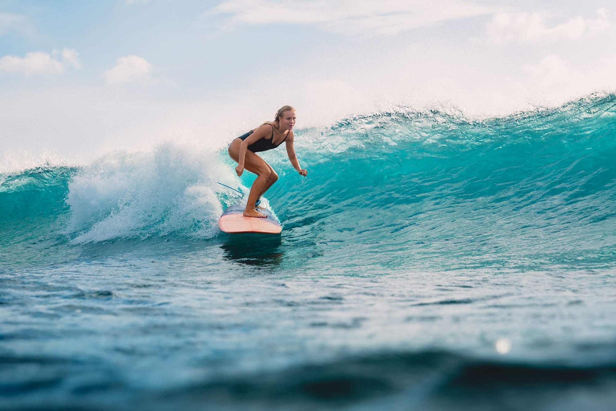 Beautiful surfer girl on surfboard. Woman in ocean during surfing. Surfer and wave. lasik icl