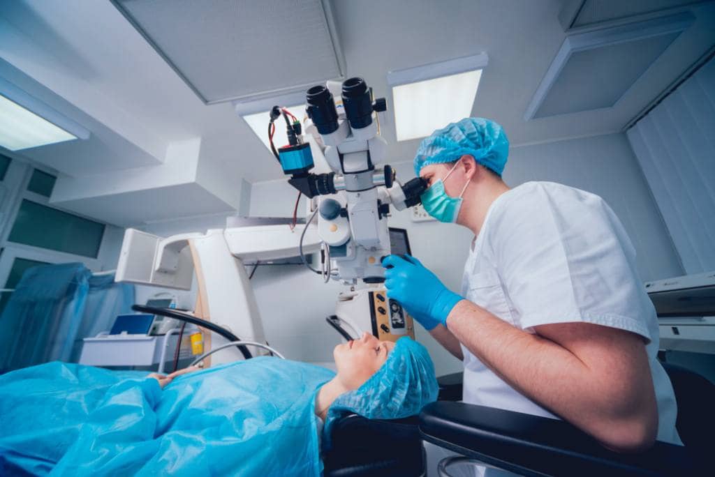 Talented LASIK eye surgeon performing procedure