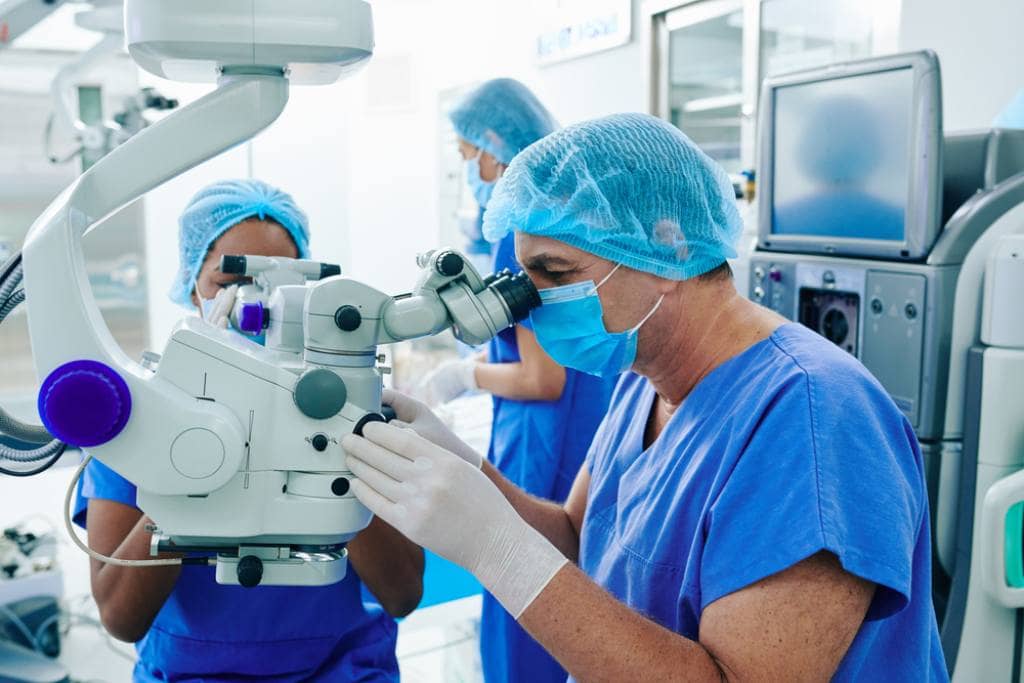 A team of surgeons performs laser eye surgery on a patient